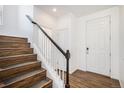 Inviting entryway featuring hardwood floors, a staircase with white railings, and a white front door at 5367 Spring Ridge Trl, Castle Rock, CO 80104