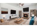 Inviting living room features a fireplace, hardwood floors, and ample natural light for a cozy atmosphere at 5367 Spring Ridge Trl, Castle Rock, CO 80104