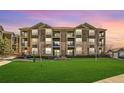 Condominium building with a well-maintained lawn and attractive facade with balconies at 2855 Blue Sky Cir # 3-102, Erie, CO 80516