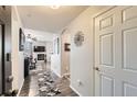 Inviting hallway leading to a living room featuring hardwood floors and neutral paint at 2855 Blue Sky Cir # 3-102, Erie, CO 80516