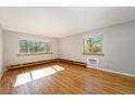 Sunlit living room with hardwood floors and large windows offering pleasant views at 1144 N Ogden St # 304, Denver, CO 80218