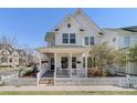 Charming two-story home featuring white siding, a cozy front porch, and a picket fence at 11687 Newton St, Westminster, CO 80031