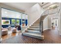 Spacious entryway featuring staircase, tiled floors, and living room at 5643 S Fulton Way, Greenwood Village, CO 80111