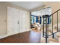Welcoming foyer with tiled floor and a view into the living room and stairway at 5643 S Fulton Way, Greenwood Village, CO 80111