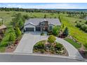 Stunning aerial view of a home with manicured landscaping, a putting green, and a scenic backdrop at 5608 Raintree Dr, Parker, CO 80134