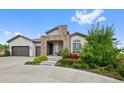 Charming home with a stone-accented entrance and well-maintained landscaping at 5608 Raintree Dr, Parker, CO 80134