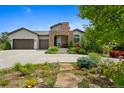 Attractive home with a stone-accented entrance, a three-car garage, and colorful landscaping in the front yard at 5608 Raintree Dr, Parker, CO 80134