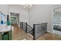 Hallway features hardwood floors, neutral walls, and staircase at 5608 Raintree Dr, Parker, CO 80134