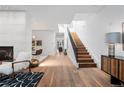 Bright foyer with hardwood floors, fireplace, and staircase leading to the upper level at 105 Fillmore St # 209, Denver, CO 80206