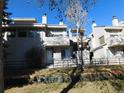 View of a townhome complex with balconies and manicured lawns at 1825 Kendall St # 205, Lakewood, CO 80214