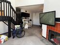 Living room featuring a fireplace, open staircase, and an attached kitchen, ready for your personal touches at 1825 Kendall St # 205, Lakewood, CO 80214