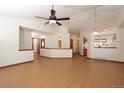 Spacious living area with wood floors, light walls, and an open layout leading to the kitchen at 3100 S Corona St, Englewood, CO 80113