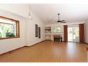 Bright living room with a fireplace, vaulted ceilings, and sliding glass doors to the backyard at 3100 S Corona St, Englewood, CO 80113