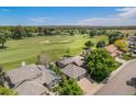Stunning aerial view of a home backing onto a lush golf course with mature trees at 1152 Clubhouse Dr, Broomfield, CO 80020