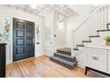 Elegant entryway with hardwood floors, decorative ceiling, and staircase with patterned carpet at 428 N Humboldt St, Denver, CO 80218
