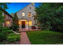 Attractive two-story home with manicured lawn, brick pathway, and comfortable outdoor seating area at 428 N Humboldt St, Denver, CO 80218