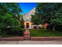 Inviting front of a two-story home with brick pathway, green lawn, and mature trees at 428 N Humboldt St, Denver, CO 80218