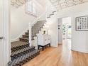 Bright staircase features patterned ceiling and a staircase with patterned carpet at 428 N Humboldt St, Denver, CO 80218