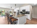 Modern kitchen featuring white cabinets, granite countertops and stainless steel appliances at 9236 Vrain Ct, Westminster, CO 80031