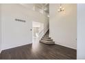 Bright living room boasts hardwood floors, high ceilings, and a staircase to the second floor at 4105 N Dunkirk Ct, Denver, CO 80249