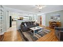 Comfortable living area with hardwood floors, a neutral color palette and access to the kitchen at 6013 S Logan St, Centennial, CO 80121