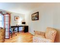 Home office with hardwood floors, built-in desk, and comfortable chair at 7024 E Montana Pl, Denver, CO 80224