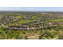Expansive aerial view of a home in a community near a golf course and green spaces at 7912 S Buchanan Way, Aurora, CO 80016