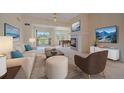 Bright living room featuring a fireplace, plush seating, and access to a balcony at 7912 S Buchanan Way, Aurora, CO 80016