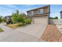 Two-story home featuring an attached two-car garage and landscaped front yard at 19047 Randolph Pl, Denver, CO 80249