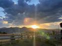 Stunning sunset view overlooking the mountains, showcasing the tranquil beauty of the surrounding landscape at 8480 Arriba Dr, Littleton, CO 80125