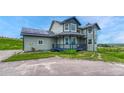 View of two-story home with gray siding, dark blue accents and a front yard at 43793 Buckskin Rd, Parker, CO 80138