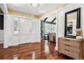 Light and airy entryway with hardwood floors, white door, and view into living area at 3824 S Xenia St, Denver, CO 80237