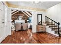 Bright entryway with hardwood floors, open staircase, and view of living room at 3824 S Xenia St, Denver, CO 80237