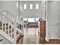 Bright and spacious entryway with hardwood floors and staircase at 5044 Basalt Ridge Cir, Castle Rock, CO 80108