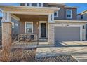 Two-story home with stone accents and a covered porch at 5044 Basalt Ridge Cir, Castle Rock, CO 80108