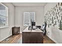 Home office with built-in desk and tree wall art at 5044 Basalt Ridge Cir, Castle Rock, CO 80108