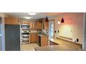 Kitchen with stainless steel appliances and wood cabinets at 14066 E 27Th Ave, Aurora, CO 80011