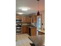 Kitchen with stainless steel appliances and wood cabinets at 14066 E 27Th Ave, Aurora, CO 80011