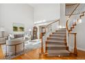 Bright foyer featuring a curved staircase, hardwood floors, and views of the living room at 15573 E Prentice Ln, Centennial, CO 80015