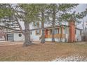 Quaint single-story home with red brick chimney and a charming front yard at 3361 S Dahlia St, Denver, CO 80222