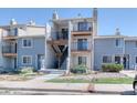 Exterior of a three-story condo featuring balconies with black iron railings and light gray painted siding at 6007 Yarrow St # D, Arvada, CO 80004