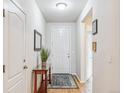 Bright entryway featuring hardwood floors, a stylish rug, and a charming console table at 6308 Walnut Grove Way, Erie, CO 80516