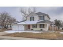 Attractive two-story home featuring a covered front porch and a three car garage at 13158 W 62Nd Dr, Arvada, CO 80004