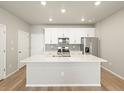 Contemporary kitchen featuring white cabinets, stainless steel appliances, and a quartz island at 22340 E 8Th Ave, Aurora, CO 80018