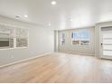 Airy living room features natural light, hardwood floors, and neutral paint at 22340 E 8Th Ave, Aurora, CO 80018