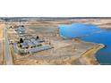 Stunning aerial view of the community with a pond, fields and the property visible, surrounded by natural beauty at 5425 County Road 32 # 27, Mead, CO 80504