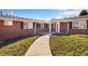 Charming brick home with a well-manicured lawn and inviting walkway at 5425 County Road 32 # 27, Mead, CO 80504