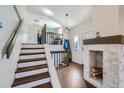 Inviting entryway with a staircase and a cozy fireplace at 10440 W 83Rd Ave, Arvada, CO 80005