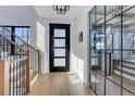 Bright foyer with hardwood floors, glass paneled doors, and a staircase leading to the upper level at 352 S High St, Denver, CO 80209