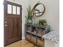 Stylish entryway with a console table, mirror, and decorative plants at 16581 Buckthorn Ln, Parker, CO 80134
